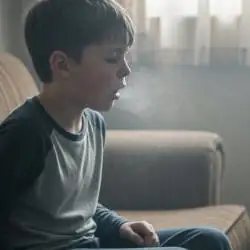 A child coughing up dusty air