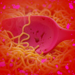 A pink plastic spatula in noodles, pink particles and a red blurred border signal danger